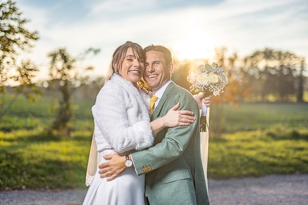 Les mariés tout sourire dans une belle nature genevoise au soleil couchant